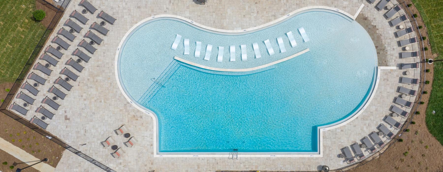 a large circular building with a pool